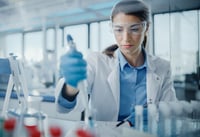 Scientist working in biopharmaceutical lab using pipettor