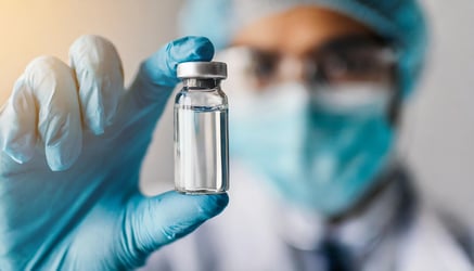 scientist holding a drug vial
