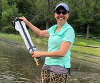 WCMC volunteer using a plankton net to collect samples for FlowCam Cyano analysis