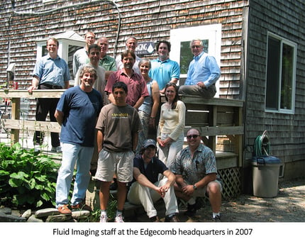 Group of 14 people on steps of shingled building