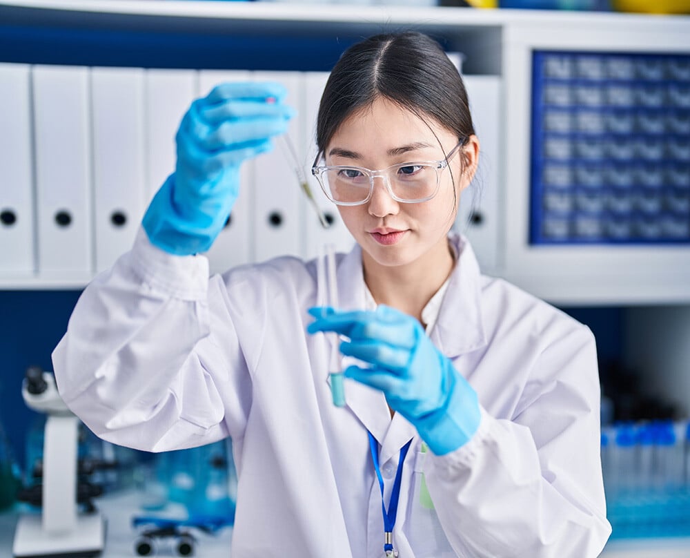 Scientist pipetting liquid into test tube